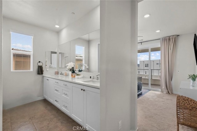 full bath featuring recessed lighting, a sink, and double vanity