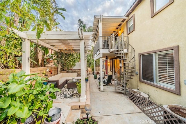 view of patio / terrace featuring an outdoor hangout area, stairway, and a pergola