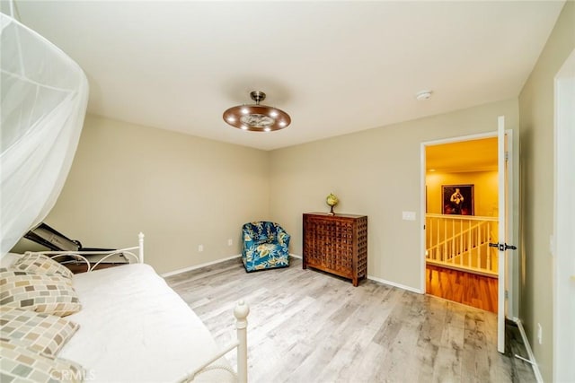 bedroom with baseboards and wood finished floors