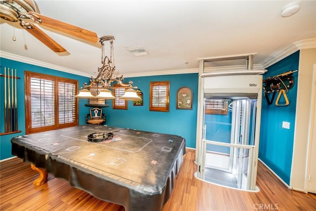 game room with ornamental molding, baseboards, visible vents, and light wood finished floors