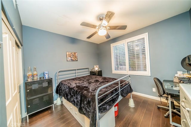 bedroom featuring dark wood-style floors, a closet, a ceiling fan, and baseboards