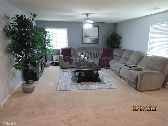 living room with visible vents, baseboards, carpet, and ceiling fan