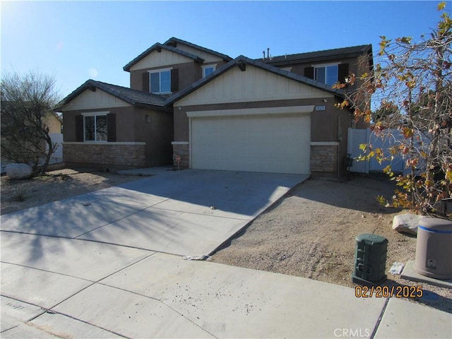 craftsman inspired home with stone siding, driveway, a garage, and fence