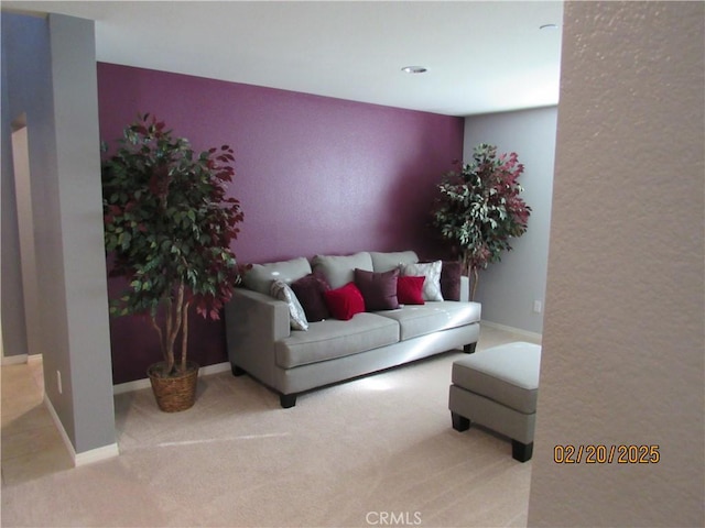 living area with baseboards and carpet flooring