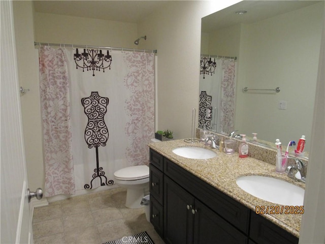 bathroom featuring a sink, toilet, double vanity, and tile patterned floors