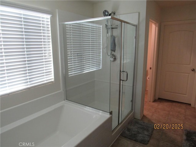 bathroom featuring a bath and a stall shower