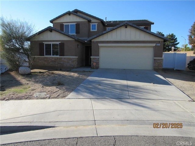 craftsman house with a garage, stone siding, and driveway