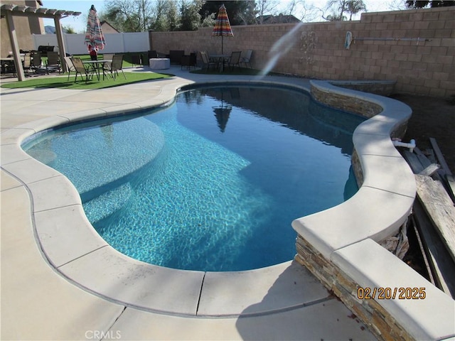 view of pool featuring a fenced in pool, a water slide, outdoor dining area, a fenced backyard, and a patio