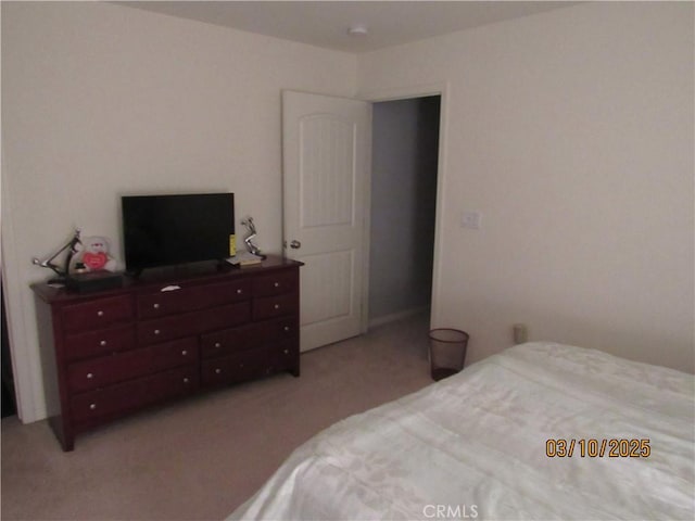 bedroom featuring light carpet