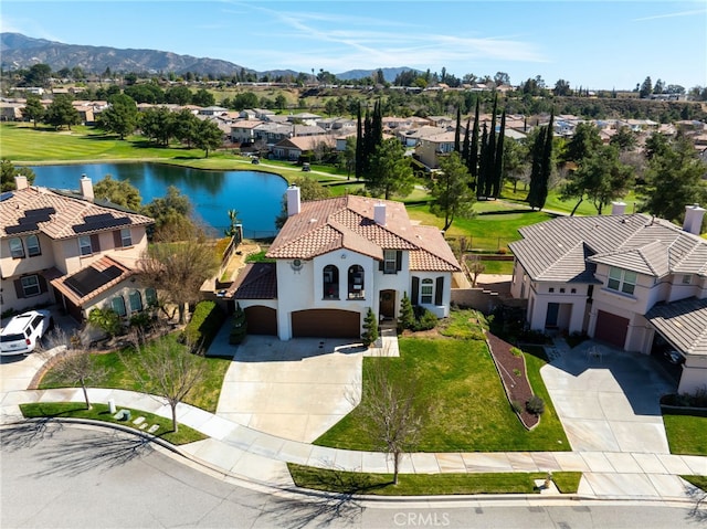 birds eye view of property featuring a water and mountain view and a residential view