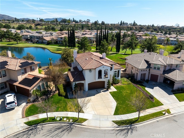 drone / aerial view featuring a water view and a residential view