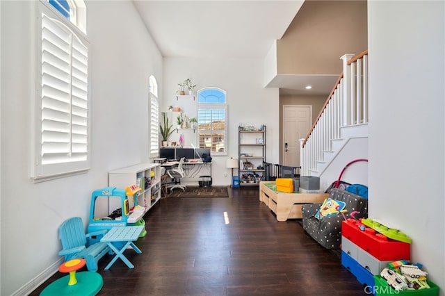 rec room with wood finished floors and baseboards