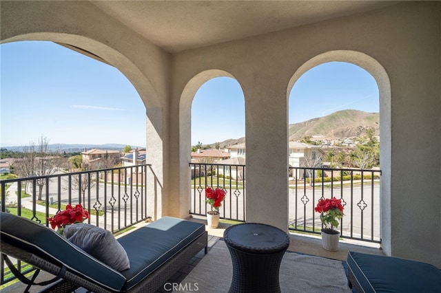 balcony with a residential view and a mountain view