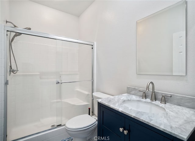 full bath with a shower stall, toilet, and vanity