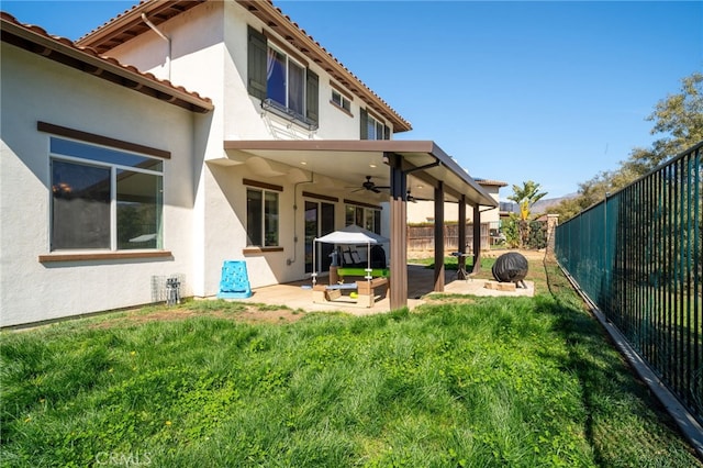 back of property with a patio area, a fenced backyard, and stucco siding