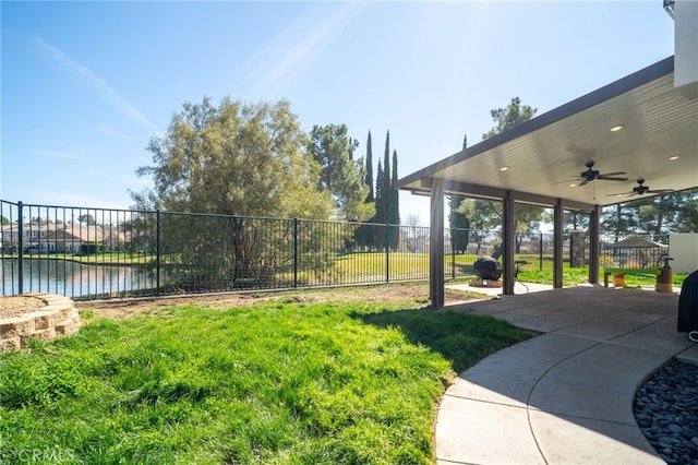 view of yard featuring ceiling fan, a patio area, and fence