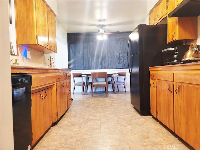 kitchen featuring ceiling fan, black appliances, brown cabinets, and under cabinet range hood