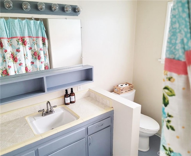 bathroom featuring vanity and toilet