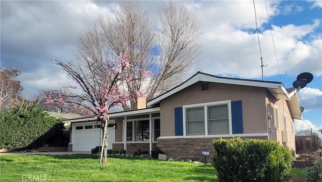 ranch-style home with stone siding, a front lawn, an attached garage, and stucco siding