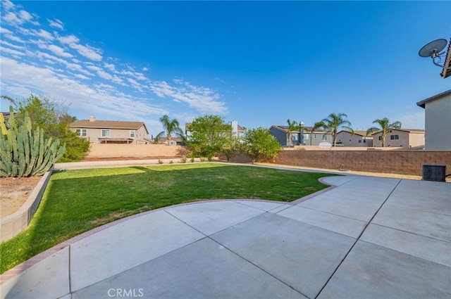 view of yard featuring a residential view, fence, and a patio