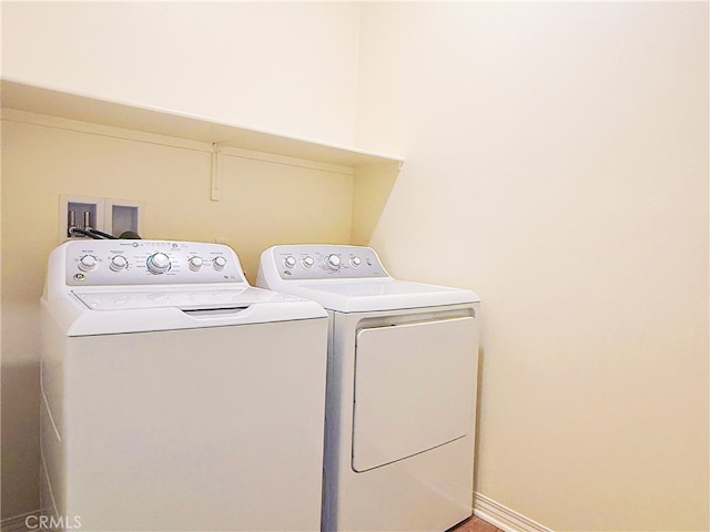 clothes washing area featuring laundry area and washer and clothes dryer