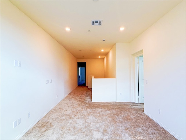 unfurnished room featuring carpet, visible vents, baseboards, and recessed lighting