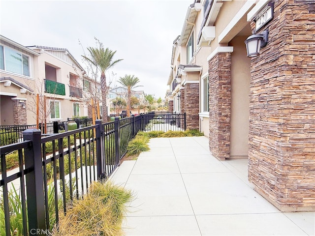 view of community with a residential view and fence