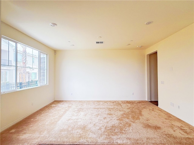 spare room with visible vents and carpet flooring