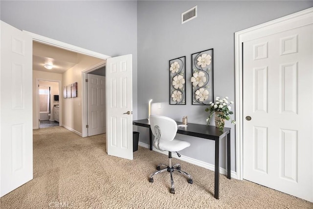 carpeted office space with visible vents and baseboards