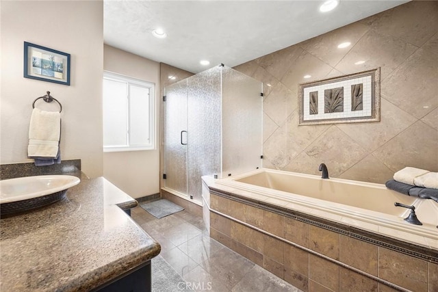 bathroom featuring recessed lighting, a shower stall, a bath, and vanity