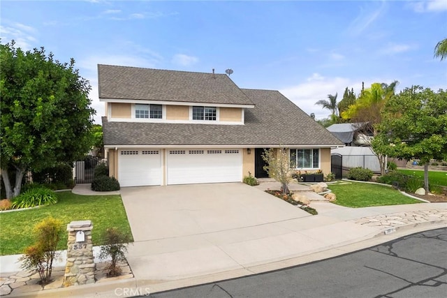 traditional-style house with a shingled roof, fence, concrete driveway, stucco siding, and a front lawn