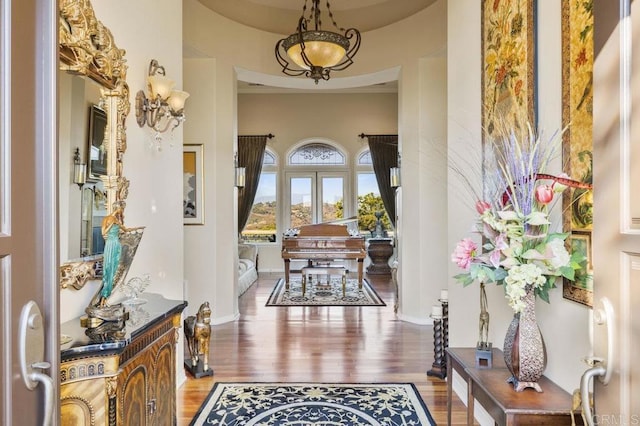 foyer entrance with baseboards and wood finished floors