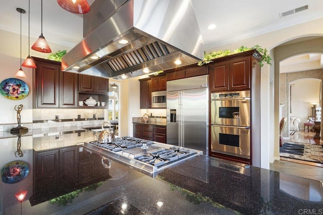 kitchen with visible vents, island exhaust hood, arched walkways, built in appliances, and crown molding