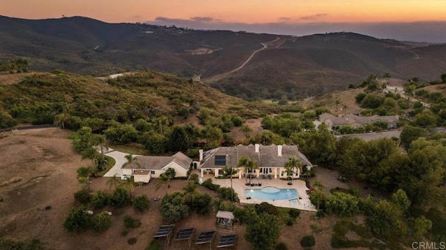 aerial view at dusk featuring a mountain view