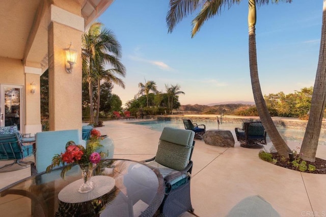 view of patio featuring outdoor dining space and an outdoor pool