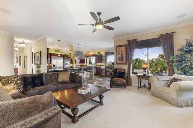 living room featuring ceiling fan, ornamental molding, a wealth of natural light, and light carpet