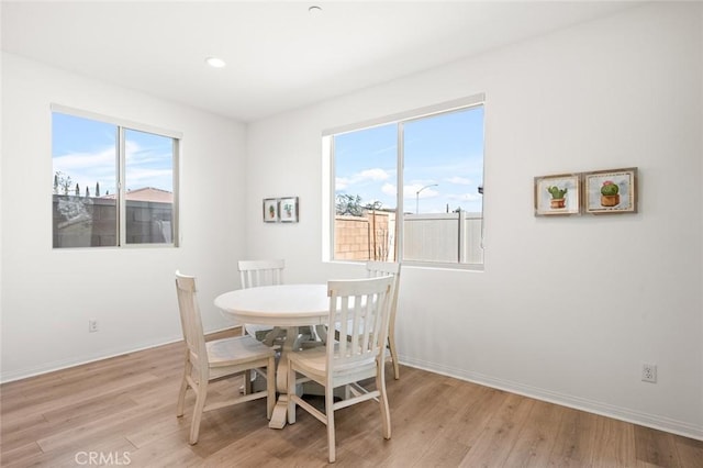 dining room with recessed lighting, light wood-type flooring, and baseboards