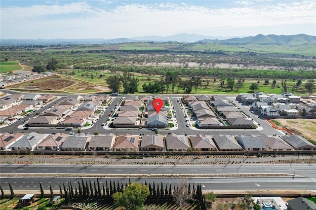 birds eye view of property with a residential view and a mountain view