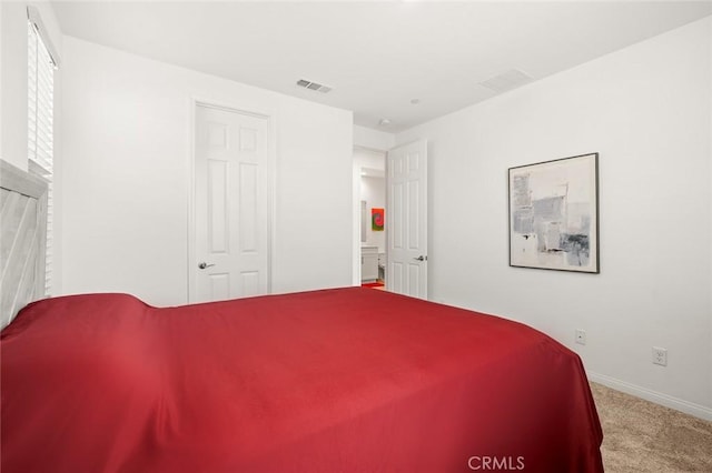 carpeted bedroom with visible vents and baseboards