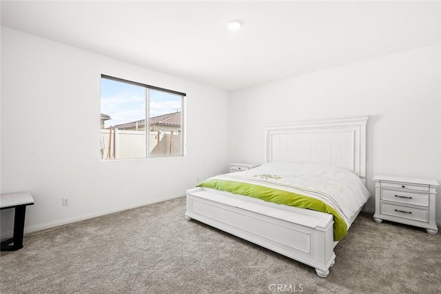 carpeted bedroom featuring baseboards