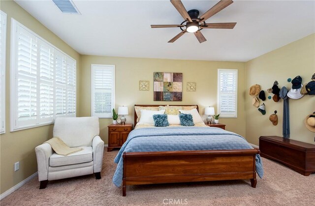 bedroom with baseboards, visible vents, carpet floors, and ceiling fan