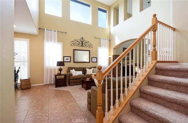 stairs with tile patterned floors and baseboards