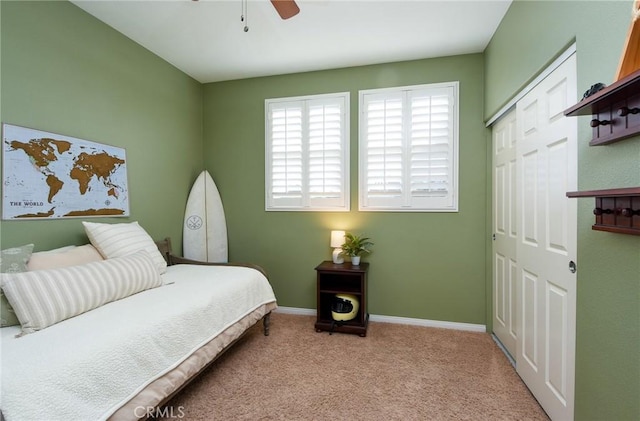 bedroom with a closet, a ceiling fan, baseboards, and carpet floors