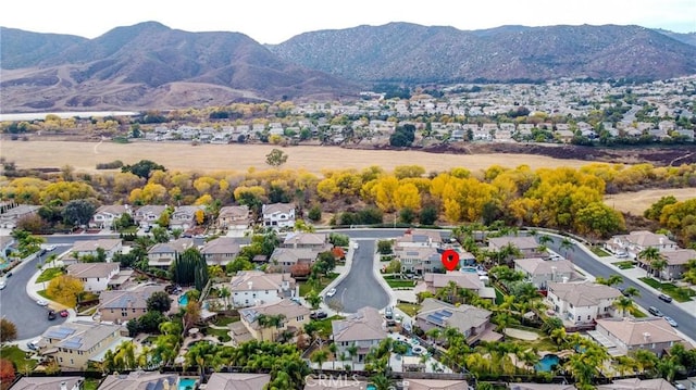 drone / aerial view featuring a residential view and a mountain view