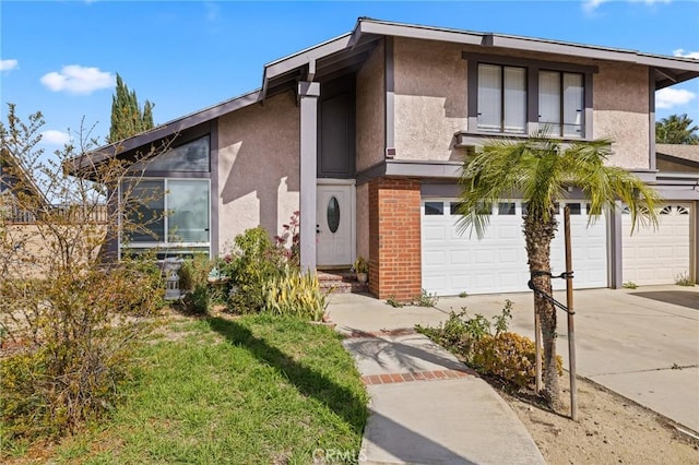 view of front of property with concrete driveway, an attached garage, and stucco siding