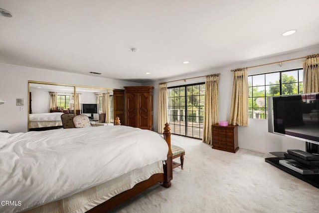 bedroom with light carpet and recessed lighting