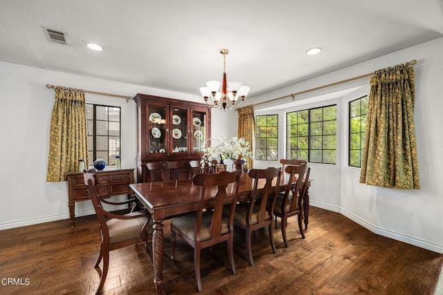 dining space featuring baseboards, visible vents, hardwood / wood-style flooring, a notable chandelier, and recessed lighting