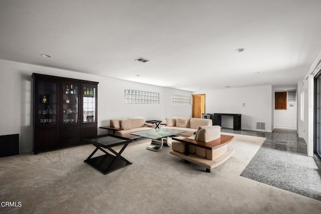 carpeted living area featuring recessed lighting and visible vents