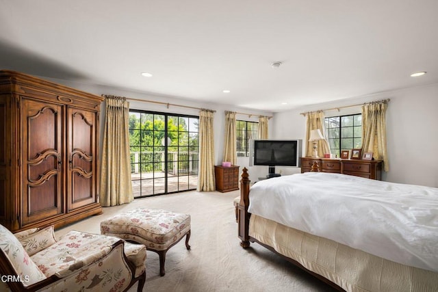 bedroom with access to outside, light colored carpet, recessed lighting, and multiple windows