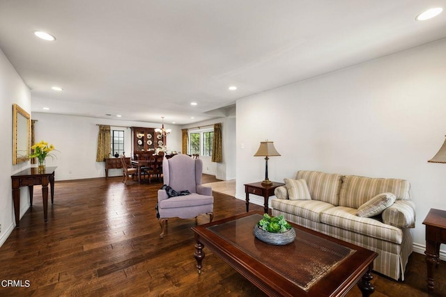 living area featuring baseboards, a notable chandelier, hardwood / wood-style flooring, and recessed lighting